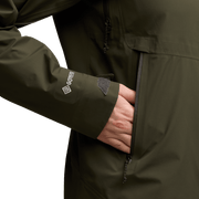 Women's Dew Point jacket sleeve close-up, dark green fabric with logo and zip detail