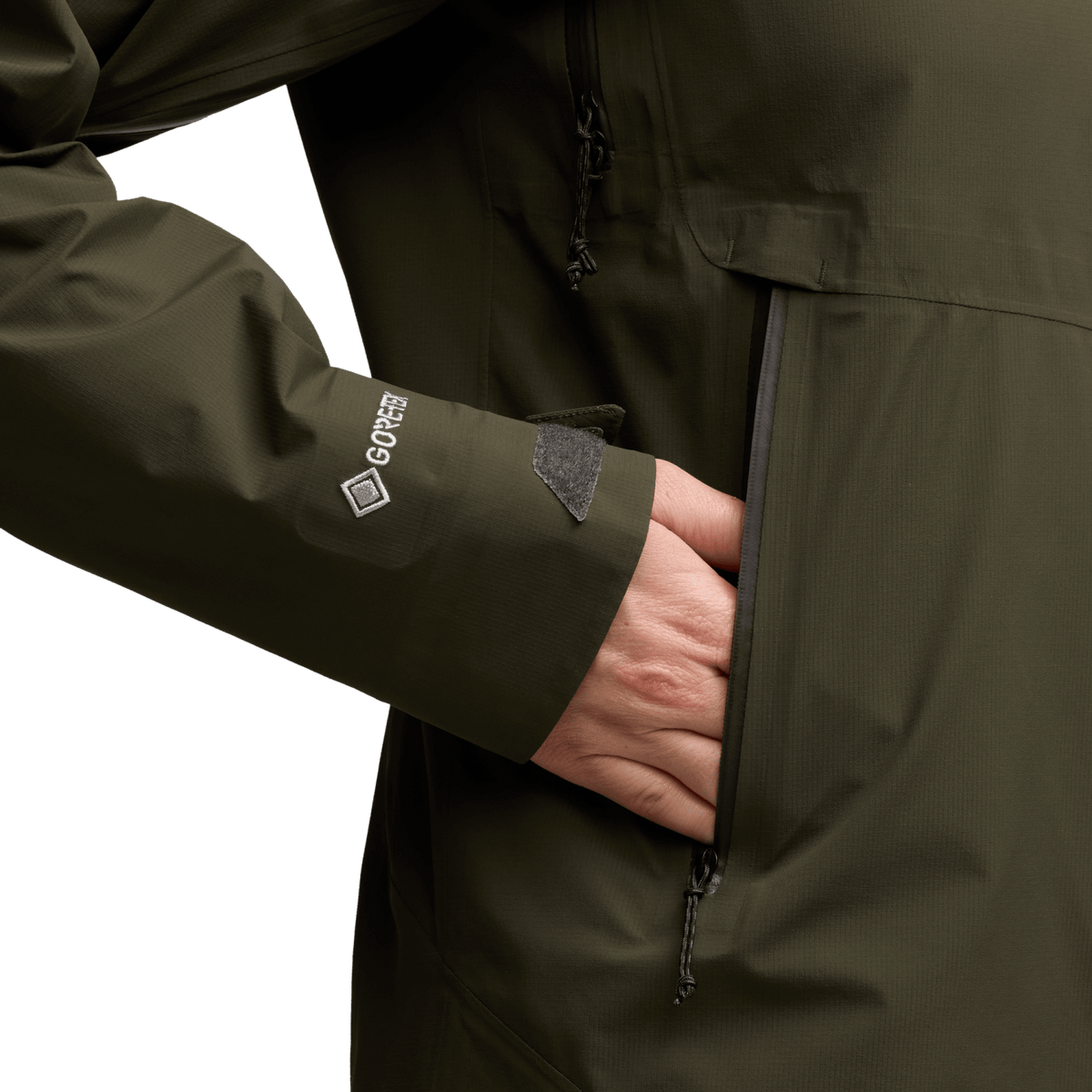 Women's Dew Point jacket sleeve close-up, dark green fabric with logo and zip detail