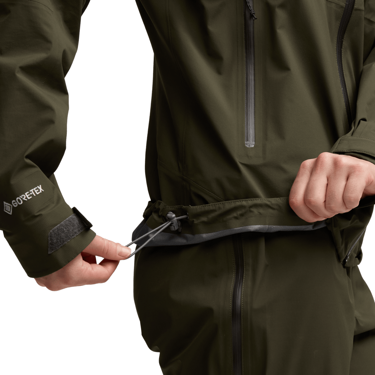 Women’s olive jacket hem drawcord and zipper detail with GORE-TEX label