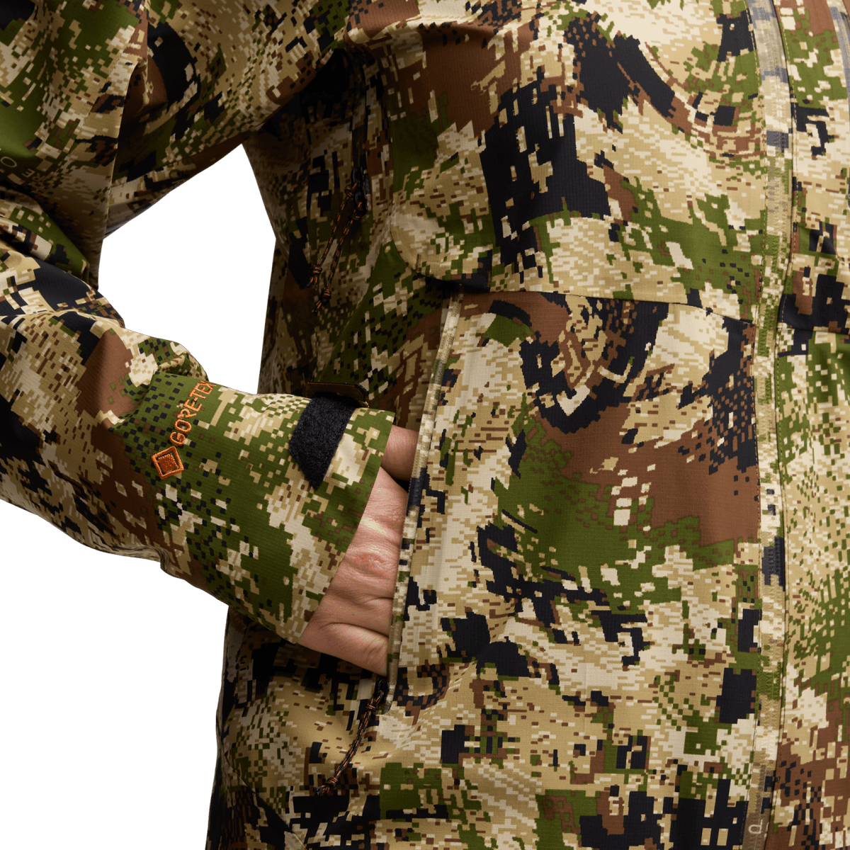 Digital camouflage jacket sleeve close-up with front zipper and hand near cuff