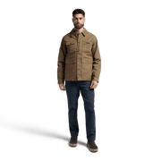 Coyote chore coat on model with button front, chest pockets, and long sleeves