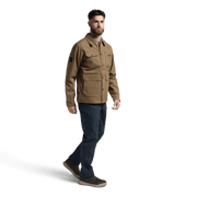 Coyote brown chore coat with long sleeves and button front, worn with jeans