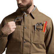 Coyote chore coat with button front and chest pockets with snap-flap detail
