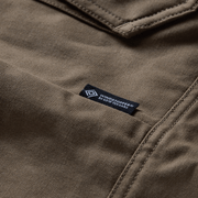 Coyote chore coat fabric label near collar seam