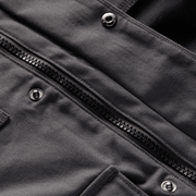 Gray chore coat detail with zippered front placket and metal snap buttons
