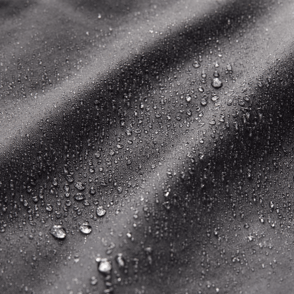 Water droplets on dark fabric texture