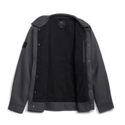 Black chore coat viewed open, showing inner lining and snap-button placket