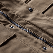 Coyote brown chore coat close-up of zipper, buttons, and reinforced seams