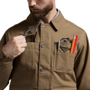 Coyote chore coat detail with tools in front utility pockets