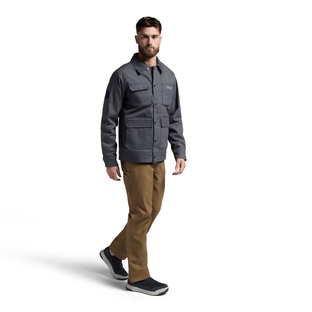 Iron grey chore coat on model, full sleeves with flap pockets and snap front