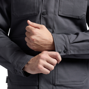 Dark gray chore coat sleeve with button cuff and chest pocket detail