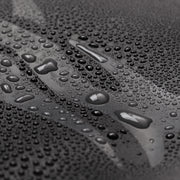 Waterproof fabric close-up with water droplets on textured surface