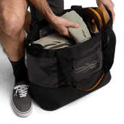 Black 40L tote bag with open top and side pocket, showing interior storage