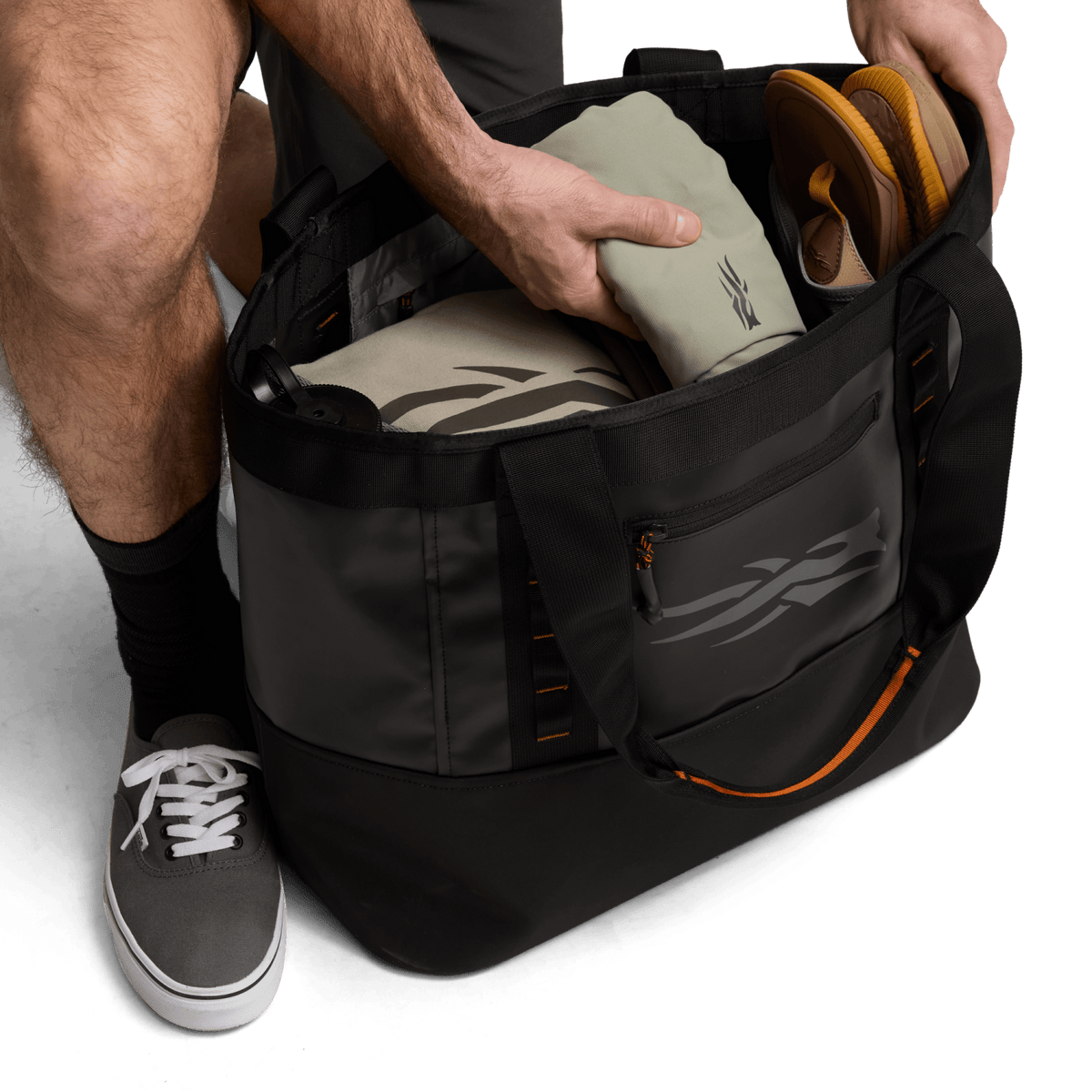 Black 40L tote bag with open top and side pocket, showing interior storage
