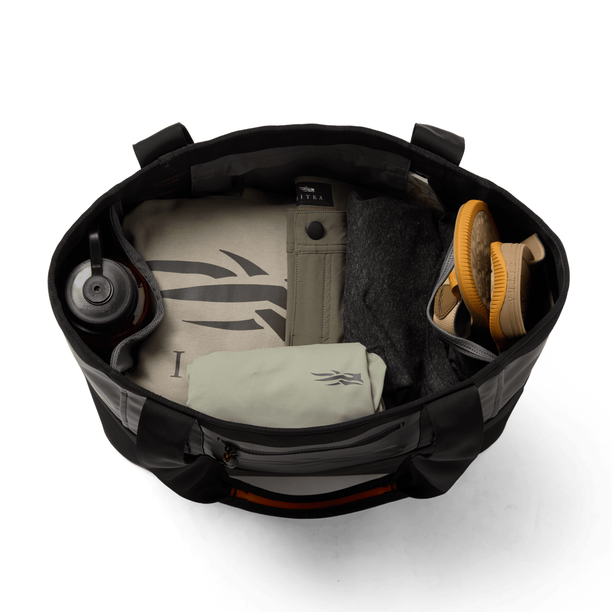 Open black 40L tote bag interior with pockets, bottle, and gear organizer