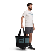 40L tote bag in gravel blue with black bottom and side handles, shown in use