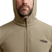 Tan fleece hooded jacket, full-zip front and chest logo, close-up view