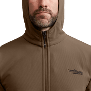 Close-up of tan/brown fleece hooded jacket with full-zip and chest logo