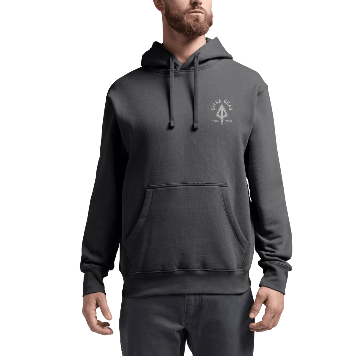 Dark gray pullover hoodie on model, with hood, drawstring, and chest logo