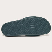 Teal slide sandal outsole with textured tread and raised logo details