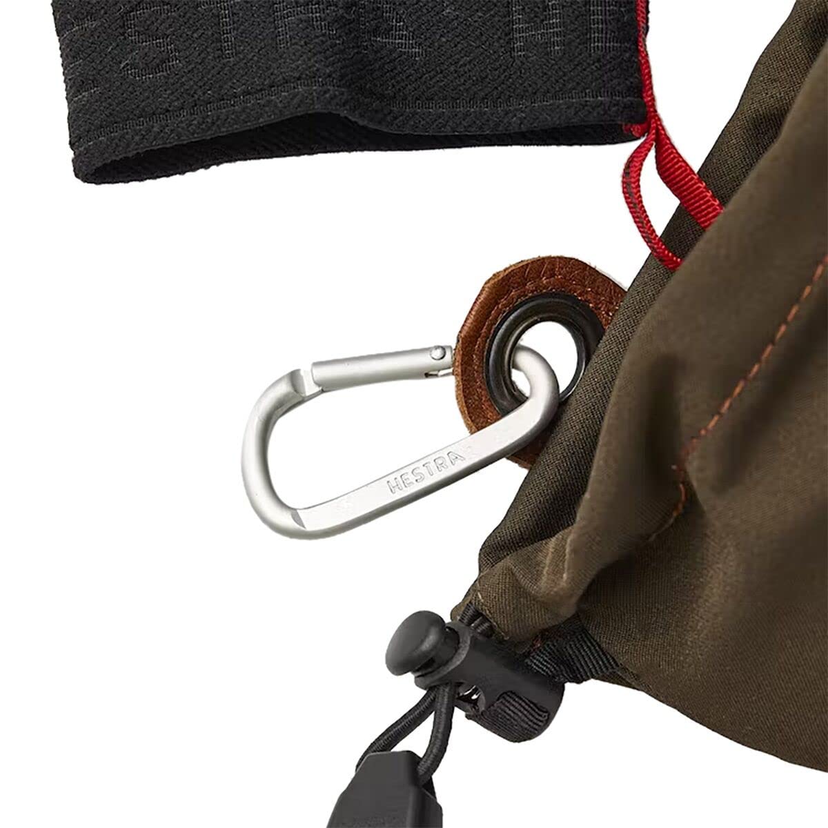 Close-up of gauntlet glove cuff with carabiner loop and drawcord adjustment.