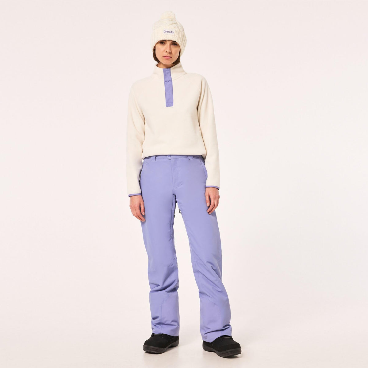 Lavender insulated ski pants with high-waist fit and Oakley label on thigh