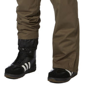 Ski pants, olive color, leg and boot view with elastic cuff and black ski footwear