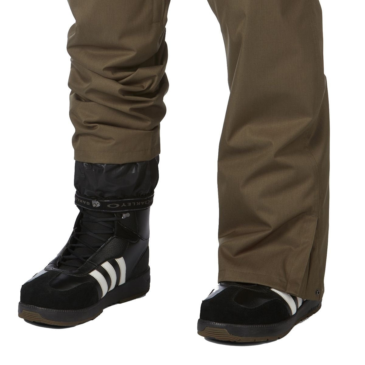 Ski pants, olive color, leg and boot view with elastic cuff and black ski footwear
