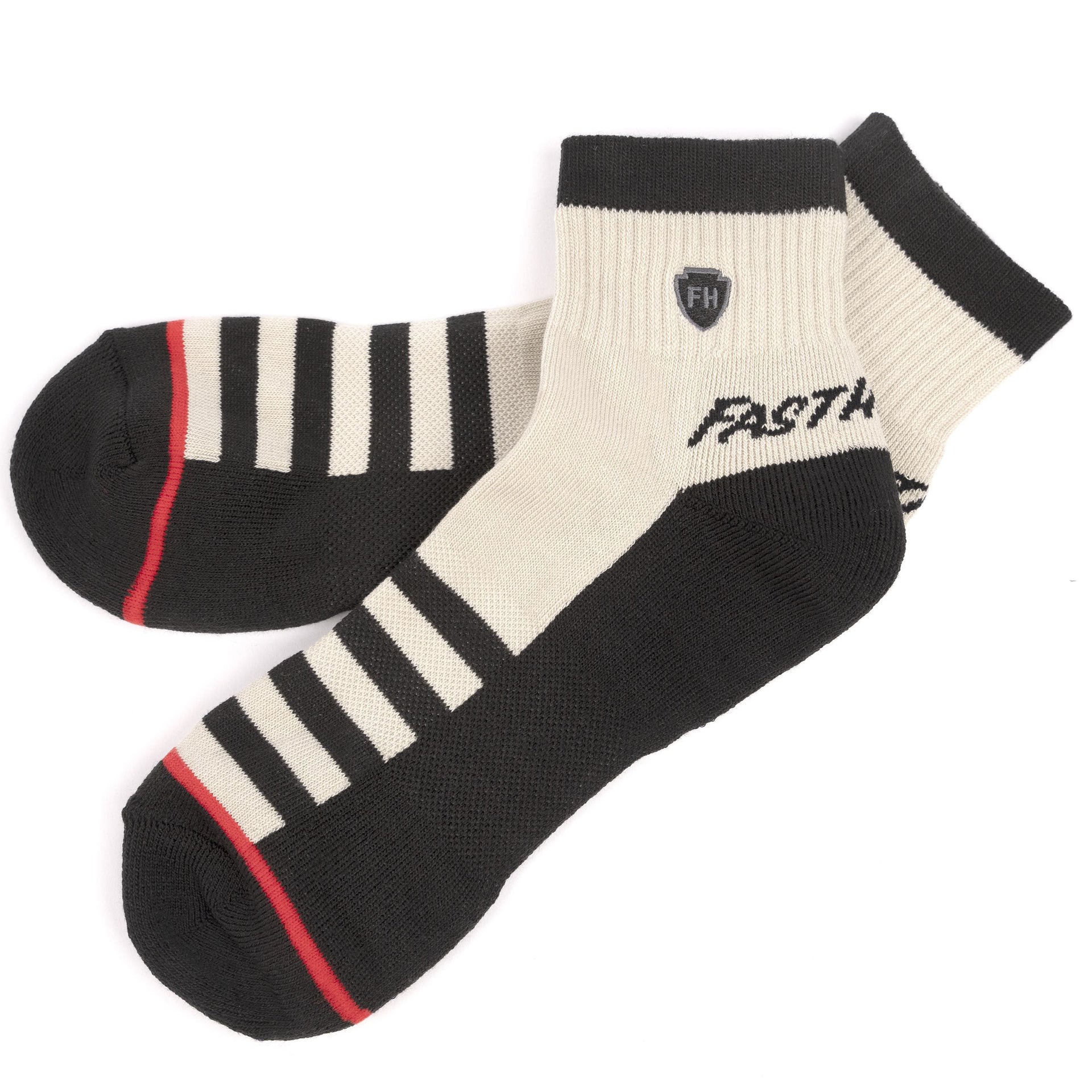 Performance ankle socks in cream and dark with striped panels and red accent line