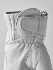 White wool gloves with stitched cuff overlay and curved thumb seam