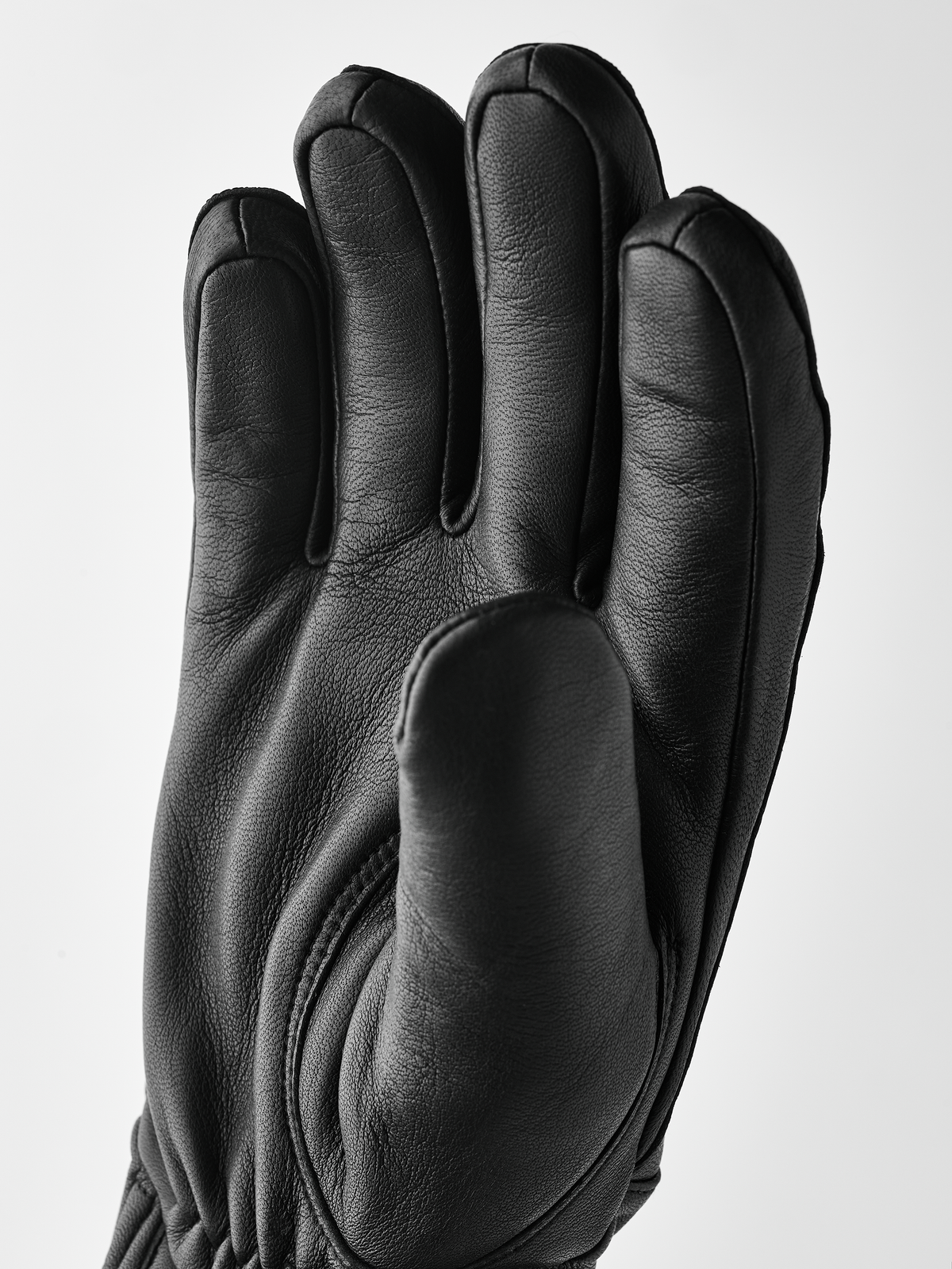 Black wool gloves with smooth leather finish and curved finger padding