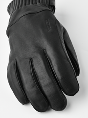 Black wool gloves with textured leather palm and stitched brand logo on back