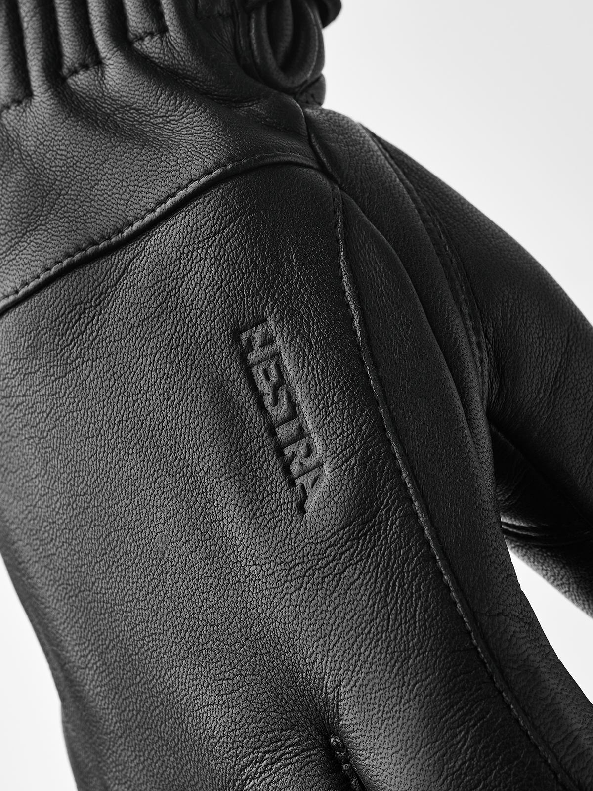 Black wool gloves with embroidered logo on back and diagonal seam detail