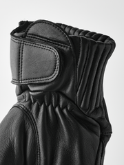 Black leather gloves with ribbed knit cuff and padded wrist panel