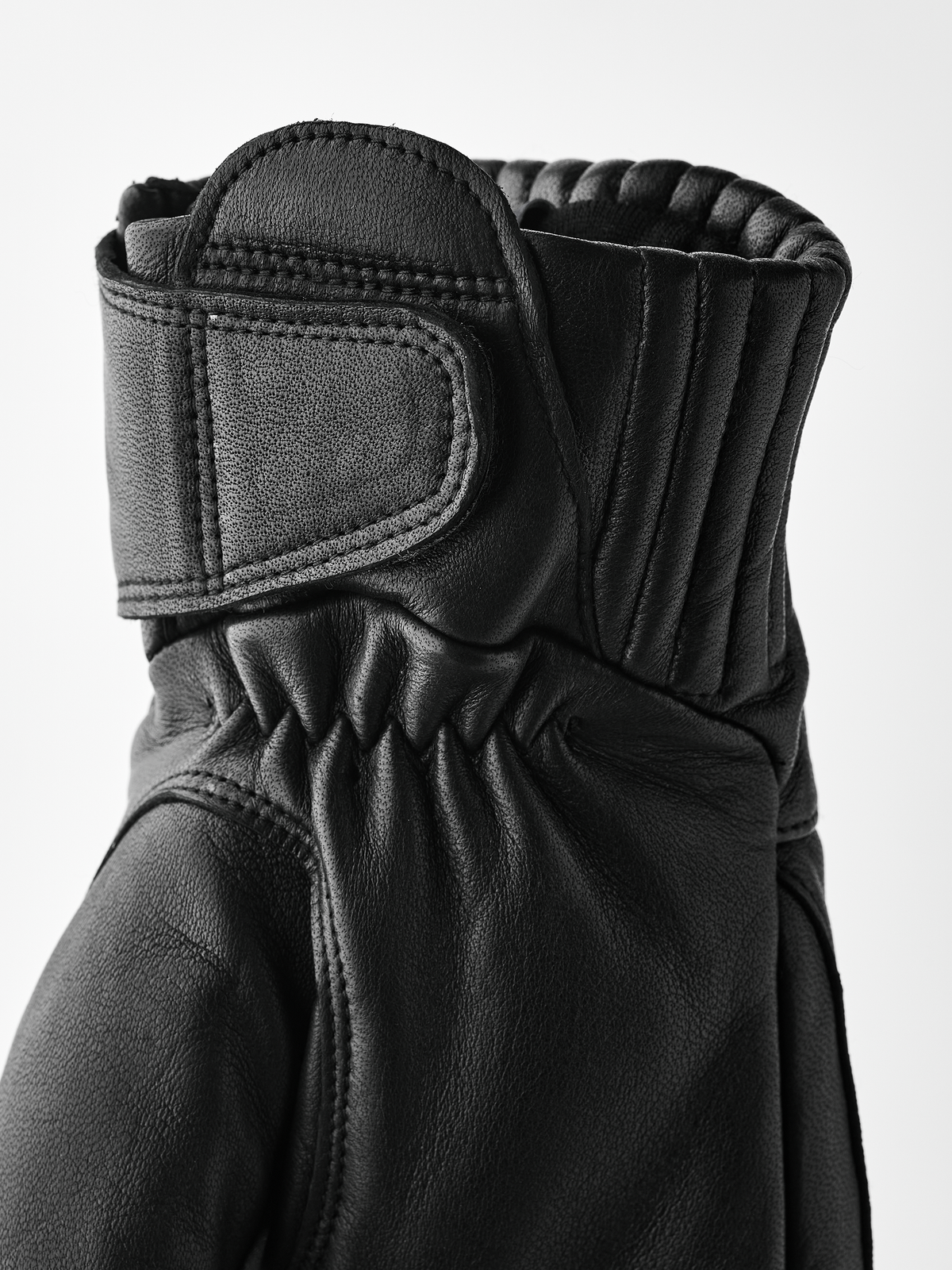 Hestra Idre wool mittens in black, padded leather palm with thumb patch