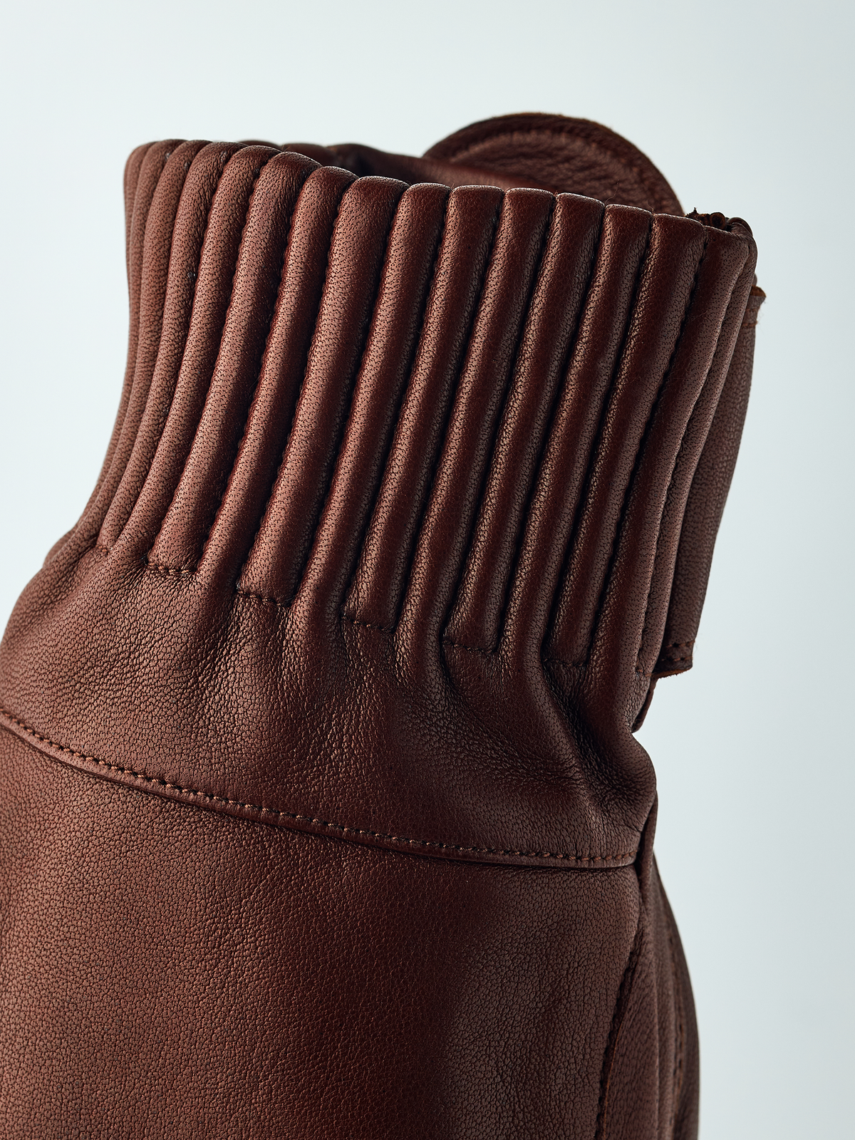 Brown wool mitten cuff with ribbed knit texture and curved leather panel