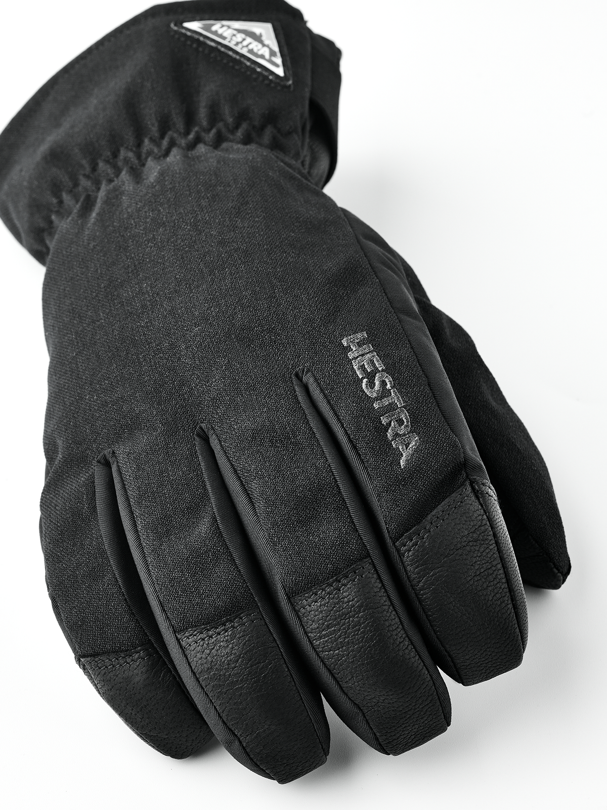 Black short gloves with Hestra logo patch and padded knuckles