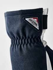 Navy powder short gloves with Hestra logo patch and elastic wrist cuff