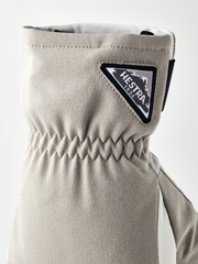 Beige powder short gloves with textured knit cuff and Hestra logo patch