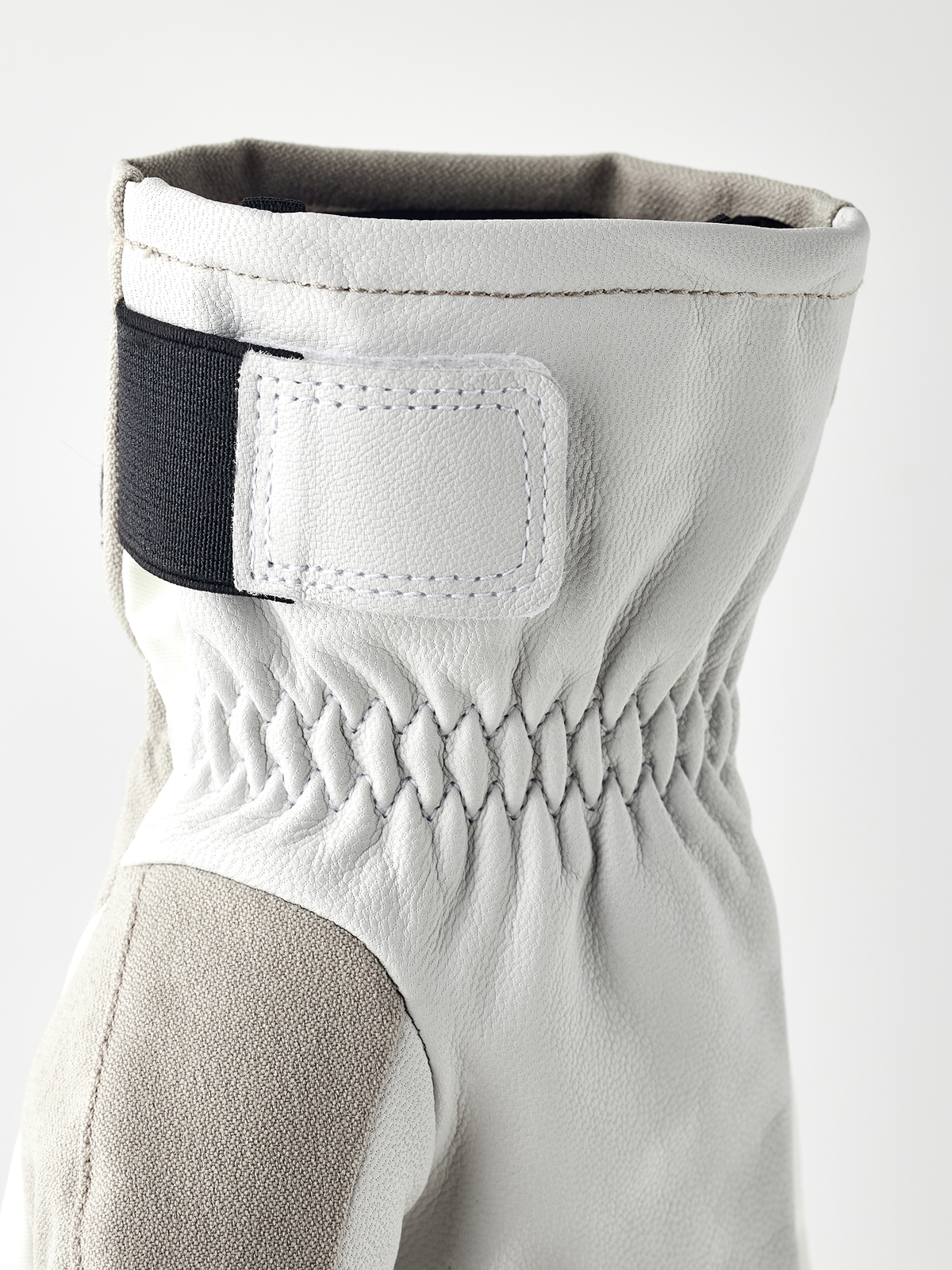 White short glove with stitched cuff and dark wrist strap