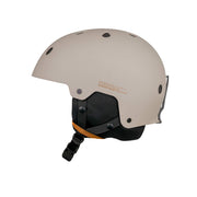 Matte putty snow helmet with black visor padding, orange accent strap, and side vents