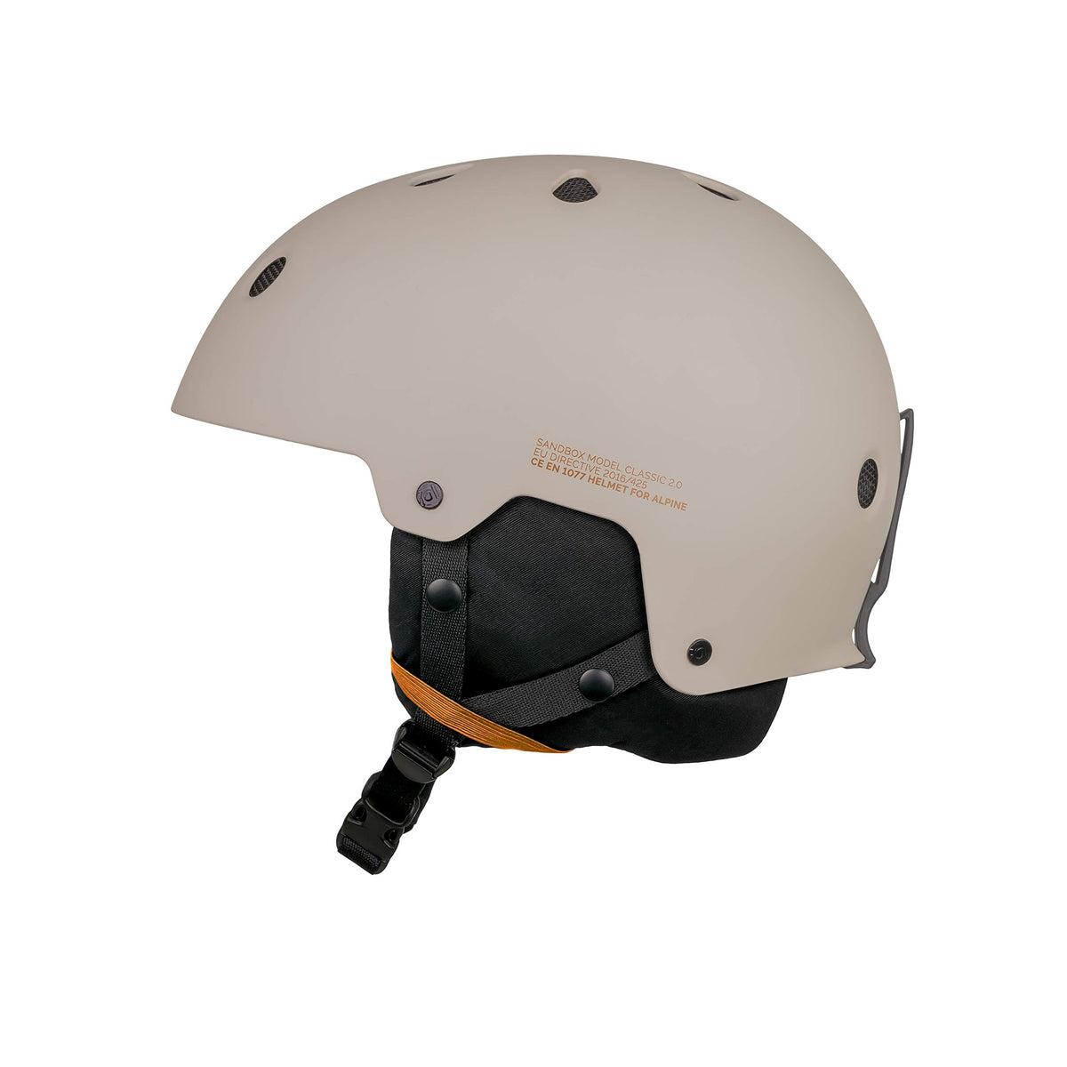 Matte putty snow helmet with black visor padding, orange accent strap, and side vents