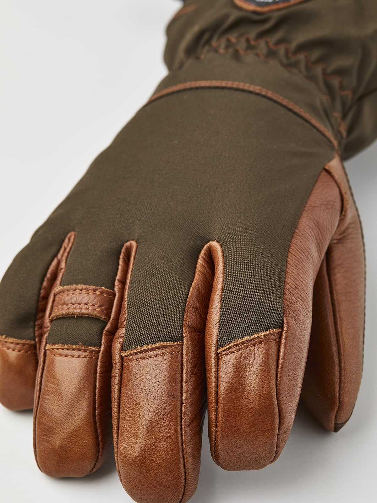 Five-finger glove hand view with brown leather fingers and dark olive outer fabric.