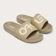 Men's slide sandals, tan upper with large white Oakley block lettering