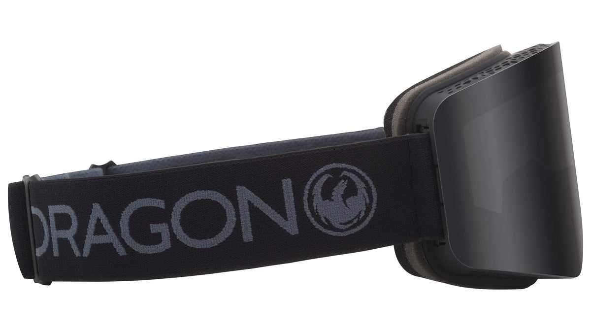 Black snow goggles with dark lens and DRAGON text across wide OTG strap