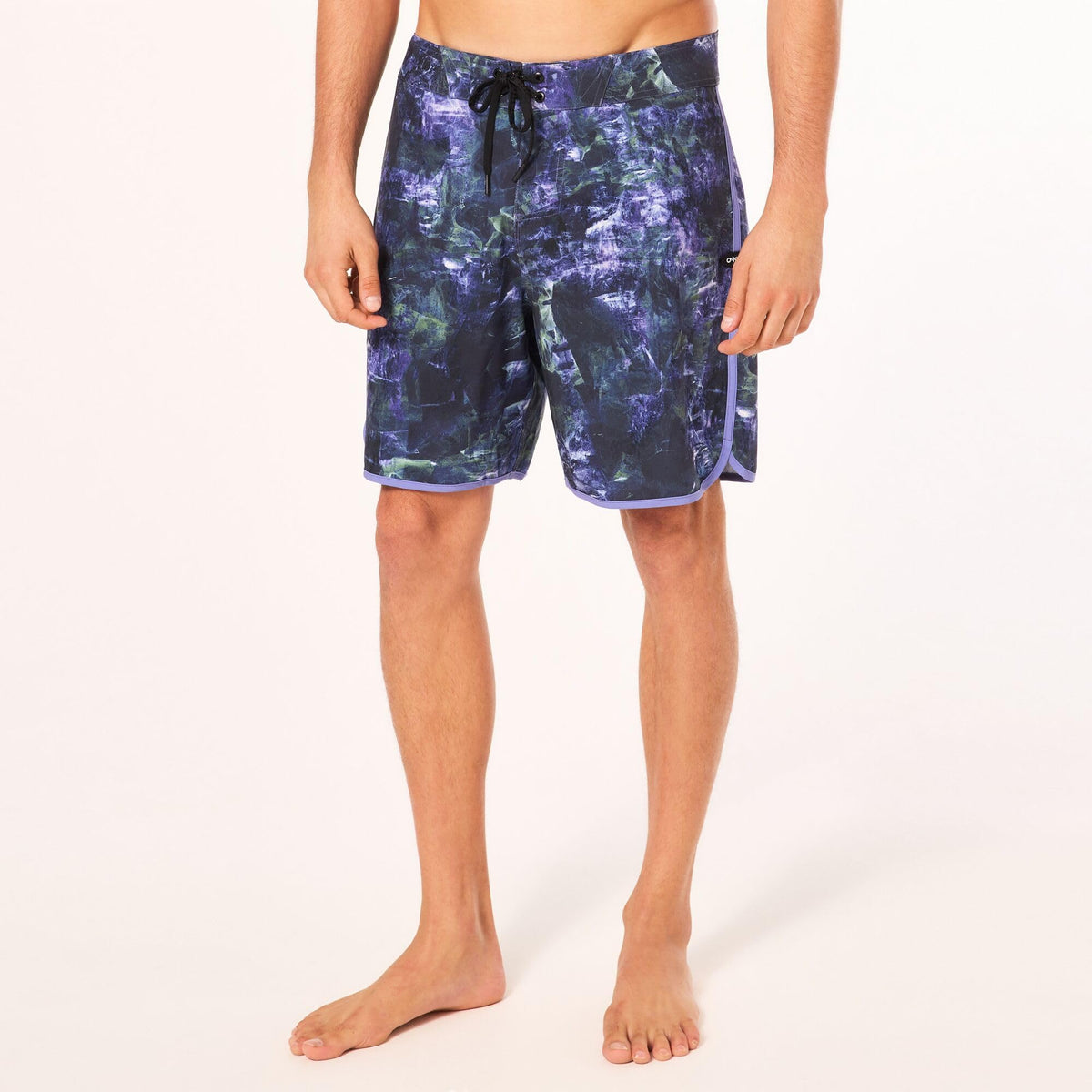 Men's Oakley 19-in board shorts on model, dark blue abstract print with black drawcord