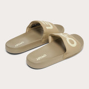 Men's slide sandals, tan cross-over straps with large Oakley logo overlays