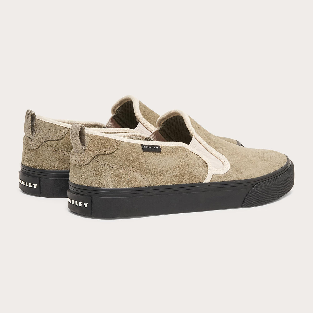 Suede slip-on sneaker with tan suede upper, white trim, black platform sole
