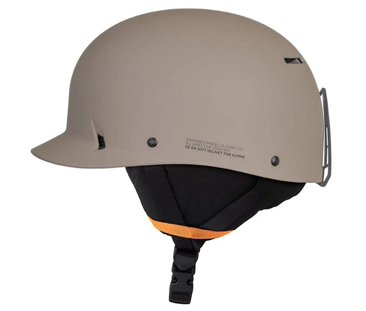 Matte taupe snow helmet side view with black padding and orange liner