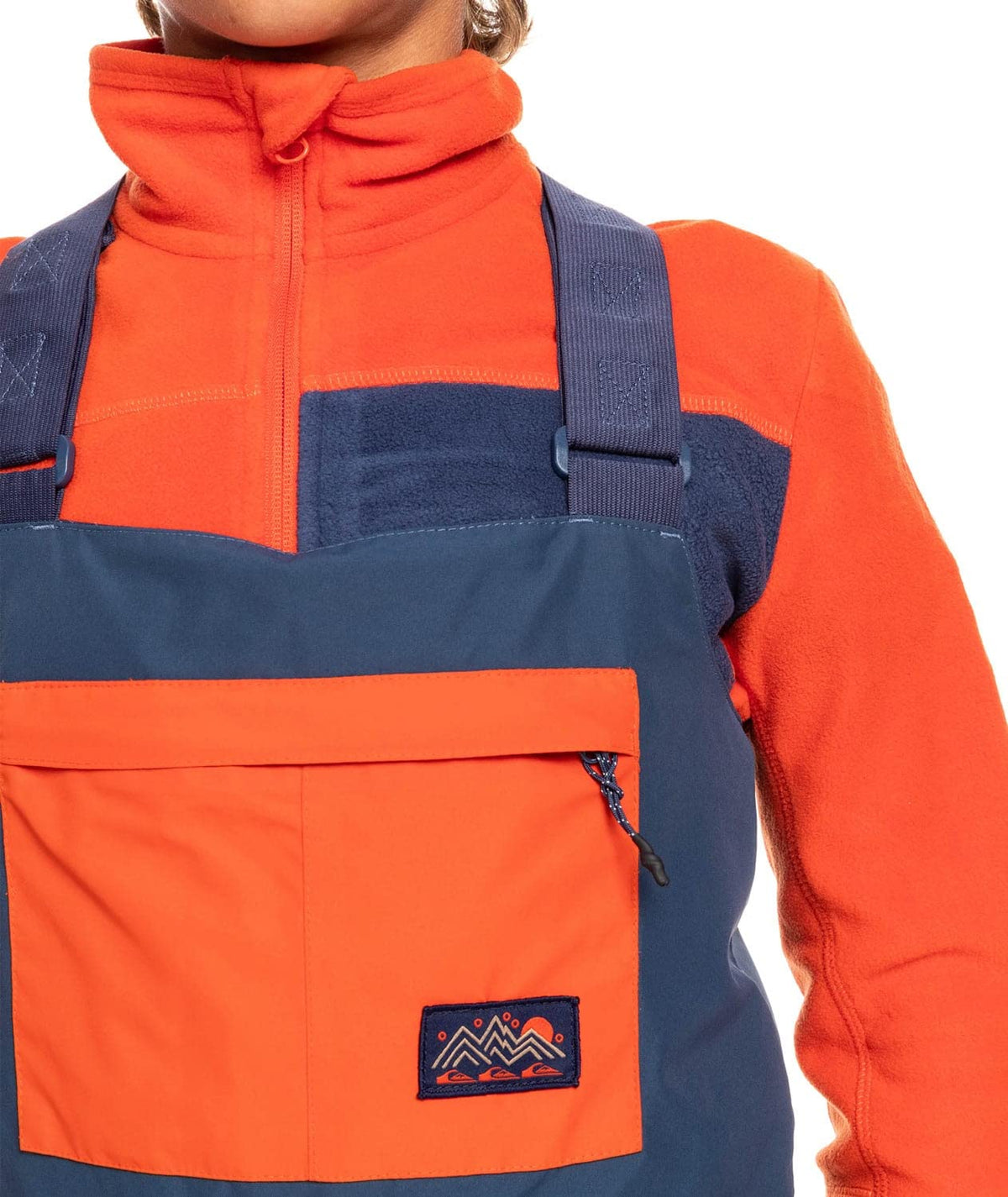 Boys' insulated snowboard bib overalls, orange vest panel with blue chest pocket and tab